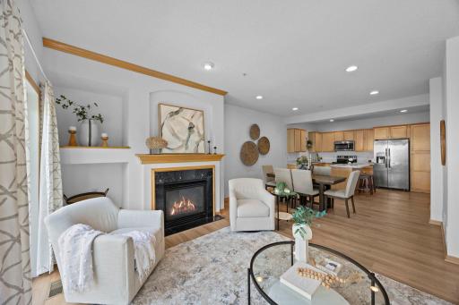 Gas fireplace creates a beautiful focal point and the open floor plan throughout the main level connects the living, dining and kitchen
