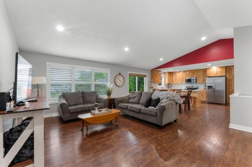 The open concept floor plan welcomes you in to the spacious area with a vaulted ceiling and large windows.