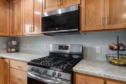 Plenty of counter space and a variety of storage options with pull drawers, cabinets, and corner storage.