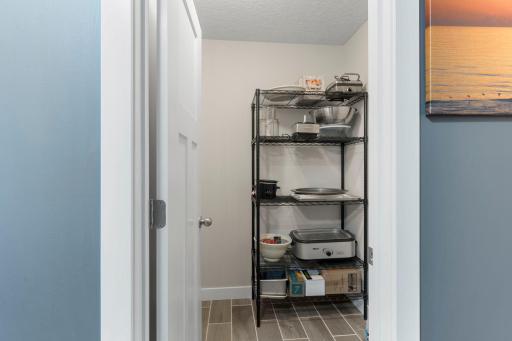 This is a large walk in storage space next to the garage entry door, many options for how the space works best for your use.