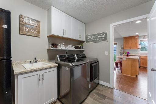 Laundry area is large enough for a sink and additional refrigerator.