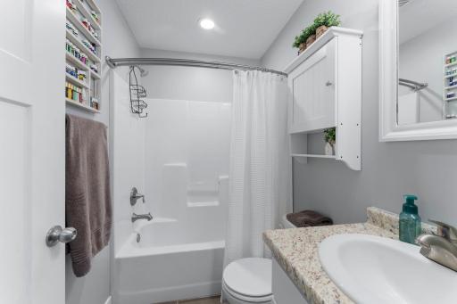 Main floor bathroom with full tub and shower located at the end of the hall by the 3 bedrooms