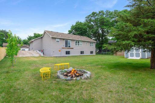 This view shows the additional parking space on the side of the house. The yard is large and flat.