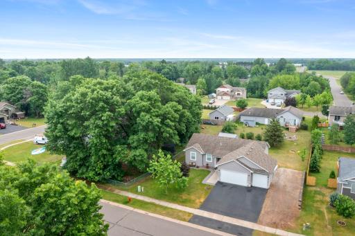Overhead shot showing paved driveway and additional parking space with retaining wall