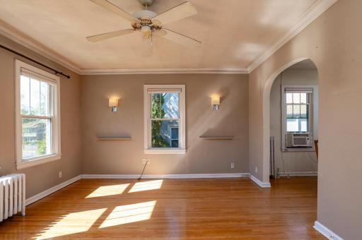 Living room with arched entry to kitchen on right