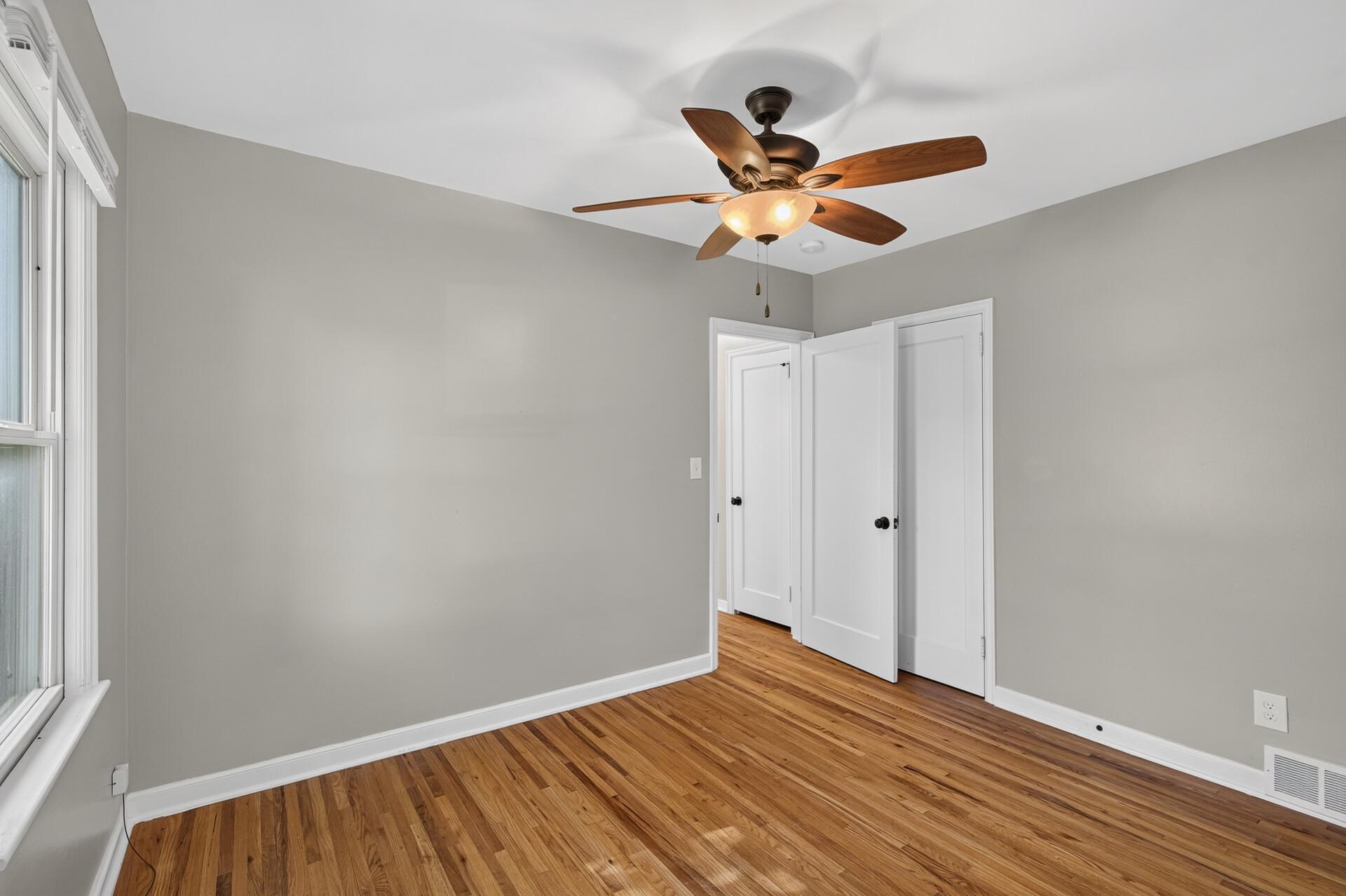 Ceiling fan and wood floors make this bedroom space ready for a new owner