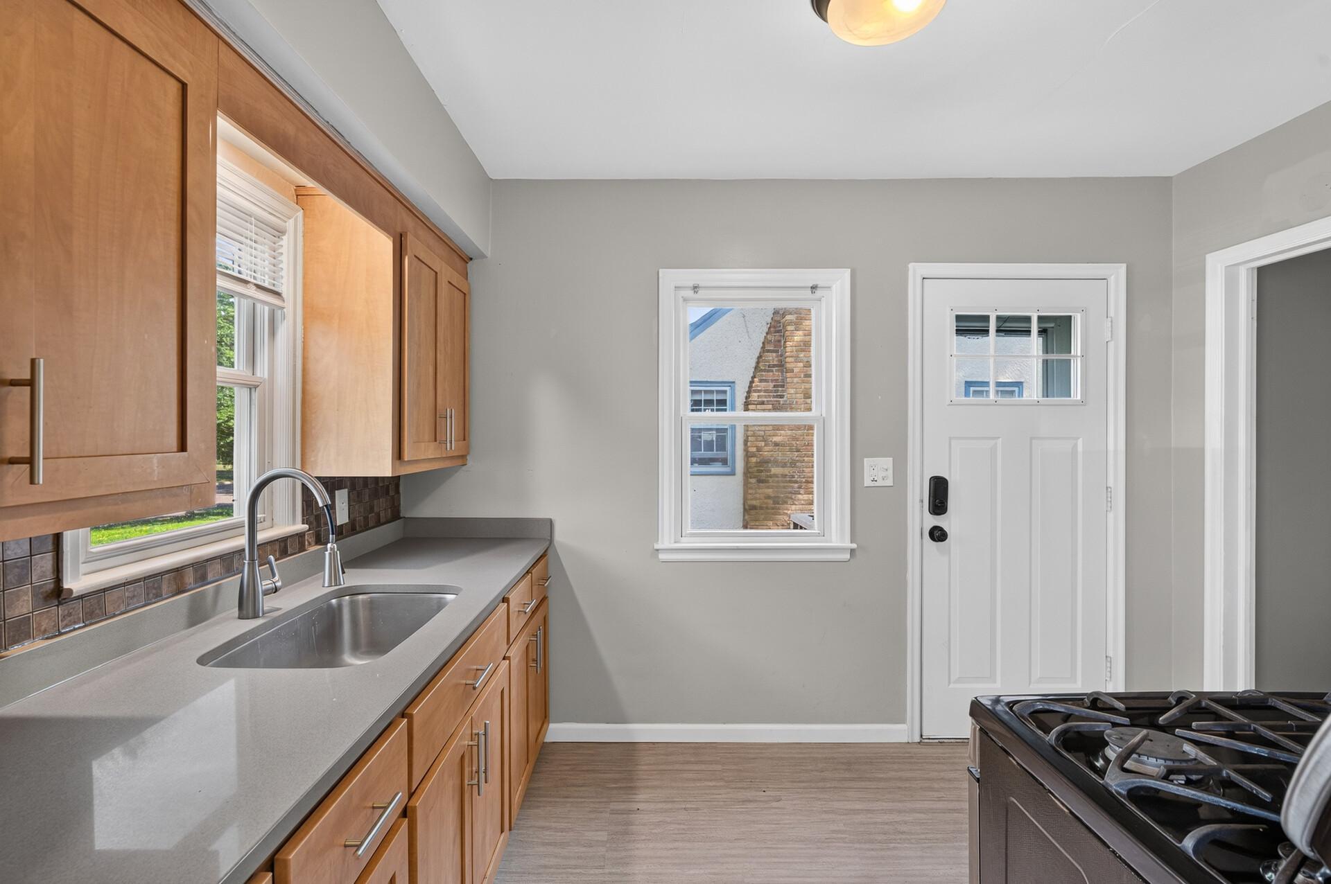 Two windows in kitchen plus glass in entrance door offers extra lighting