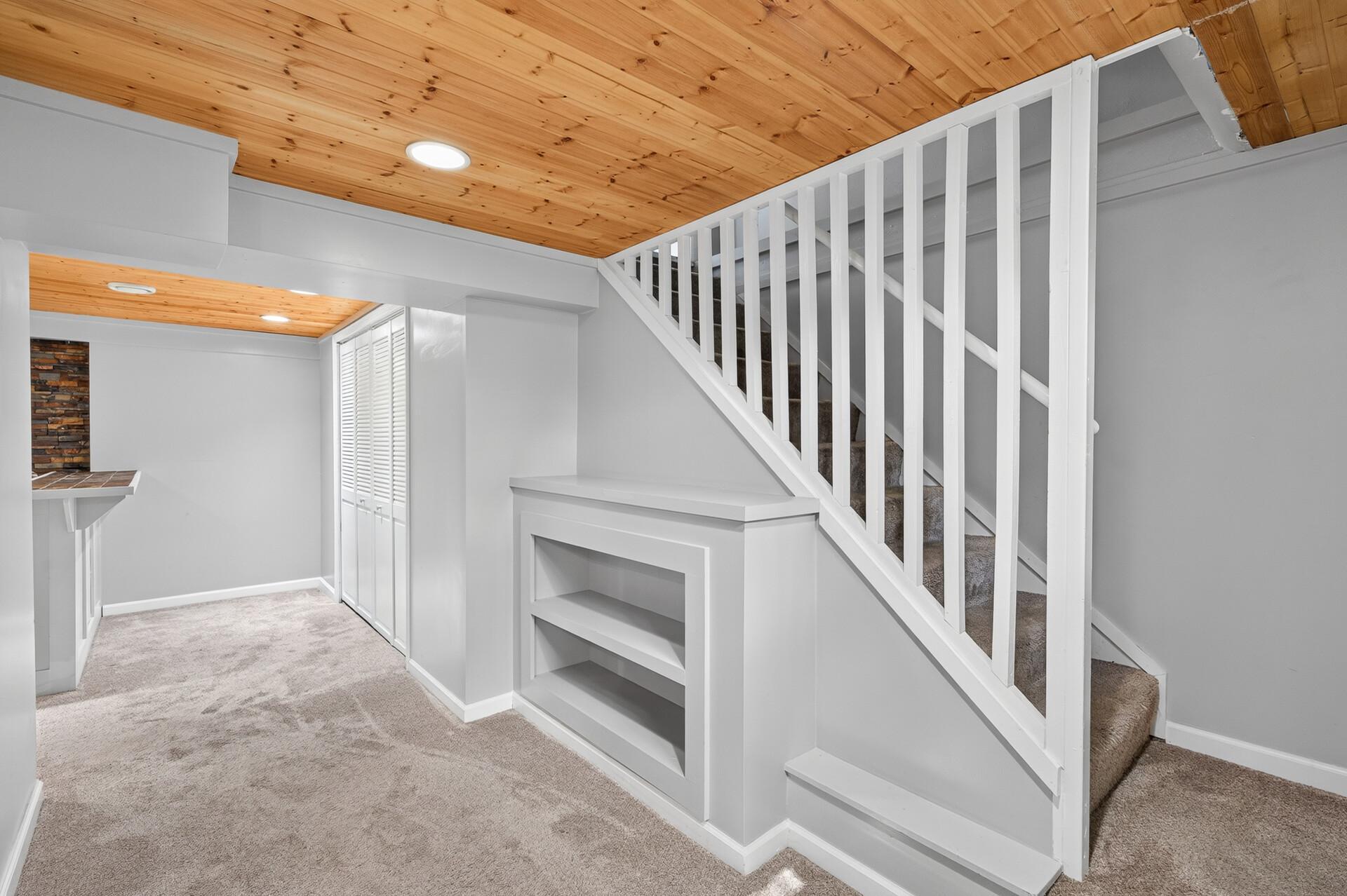 Open Railing to the lower level with Wood Ceiling accents and built in Book Shelve