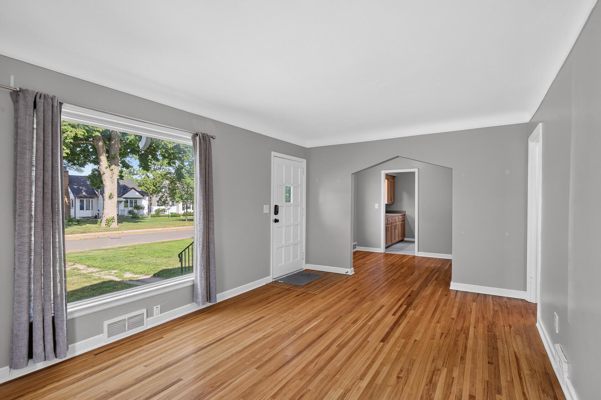 Appreciate the gleaming wood floors that flow from the living room to dining and into the bedrooms throughout the main levels