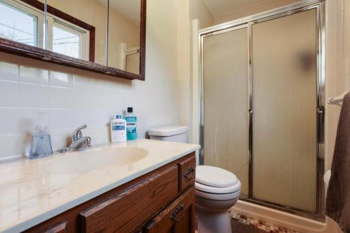 3/4 Primary Bath - tiled bath. Shower door is cracked but does not leak. AS IS