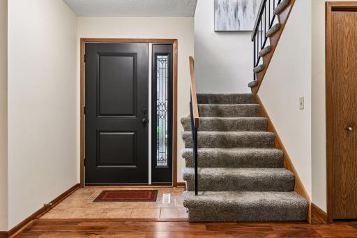 Main Front entry with New front entrance door, side light, and hardwood flooring