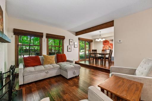Photo for 8823 Basswood Road, Eden Prairie, MN 55344 - listing #7084047 18x12 Main Floor Living room with Hardwood floors, Fireplace and north-facing windows opening up to the wooded back patio.