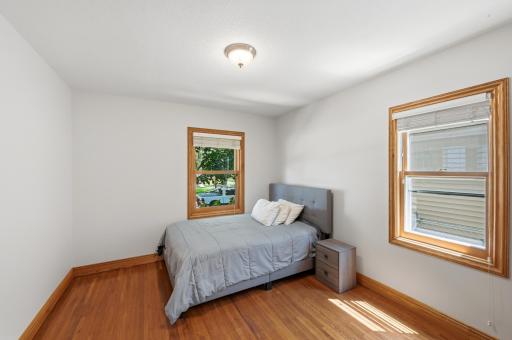 The main floor bedroom has hardwood floors and 2 large windows.