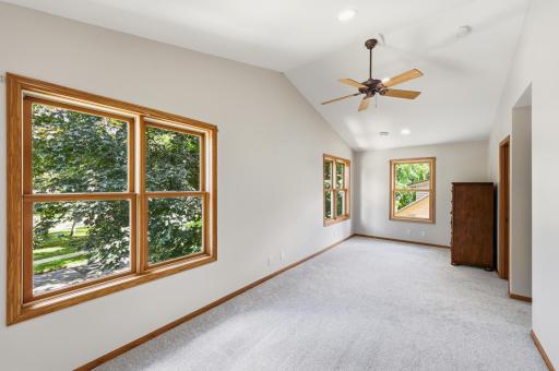 The primary bedroom has new carpet, vaulted ceilings and lots of natural light.