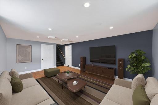 Finished basement with recessed lighting.