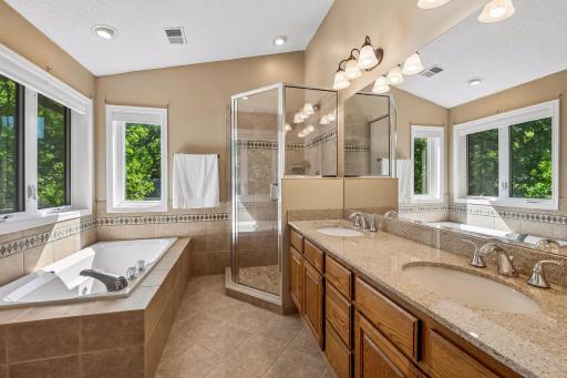 Double sinks and a separate shower and tub in the primary bathroom