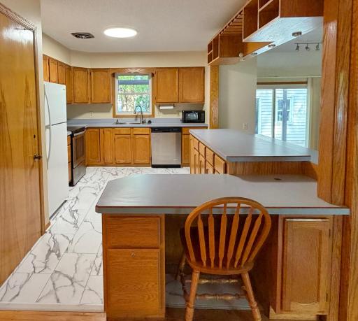 Stay Organized with a built-in desk conveniently located in the kitchen area