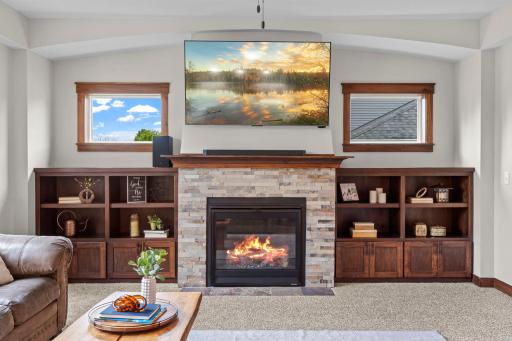 Notice all of the architectural details. The arched alcove over the the fireplace flanked by transom windows, perfect for bringing in natural light while maintaining privacy. The stacked stone surround brings warmth and character to the space.