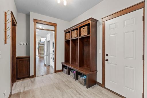 The large, thoughtfully designed mudroom features a custom built-in bench providing family friendly individual lockers with upper cubbies, coat hooks and convenient storage below. A main floor half bath and large walk-in closet round out the space.