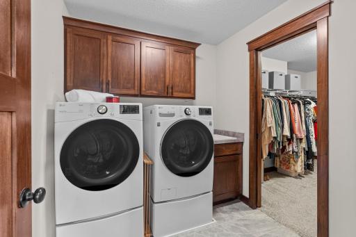This upper level laundry has an XL capacity washer and gas dryer, plenty of overhead storage, tile floor and a dedicated utility sink. The extensive use of pocket doors in this home enables every space to be maximized.