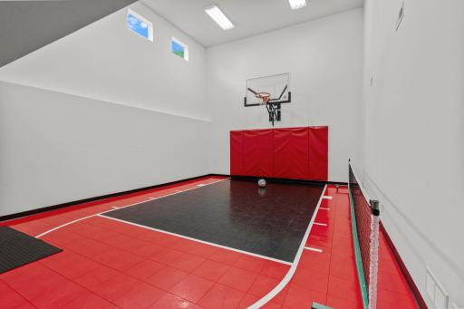 This enormous indoor sport court is large enough to take a 3-point shot. The pickleball net is on wheels and comes with the home. The net can be raised for badminton, beachball volleyball or whatever games you dream up.