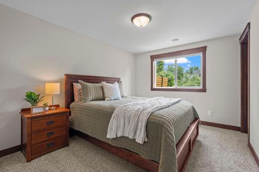 The lower level bedroom with walk-in closet with adjacent bathroom is the perfect space for visitors to stay or for an older child to have more independence.