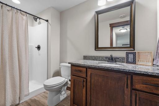A fifth bathroom with walk-in shower has the same high-end finishes for a guest or family member to enjoy.