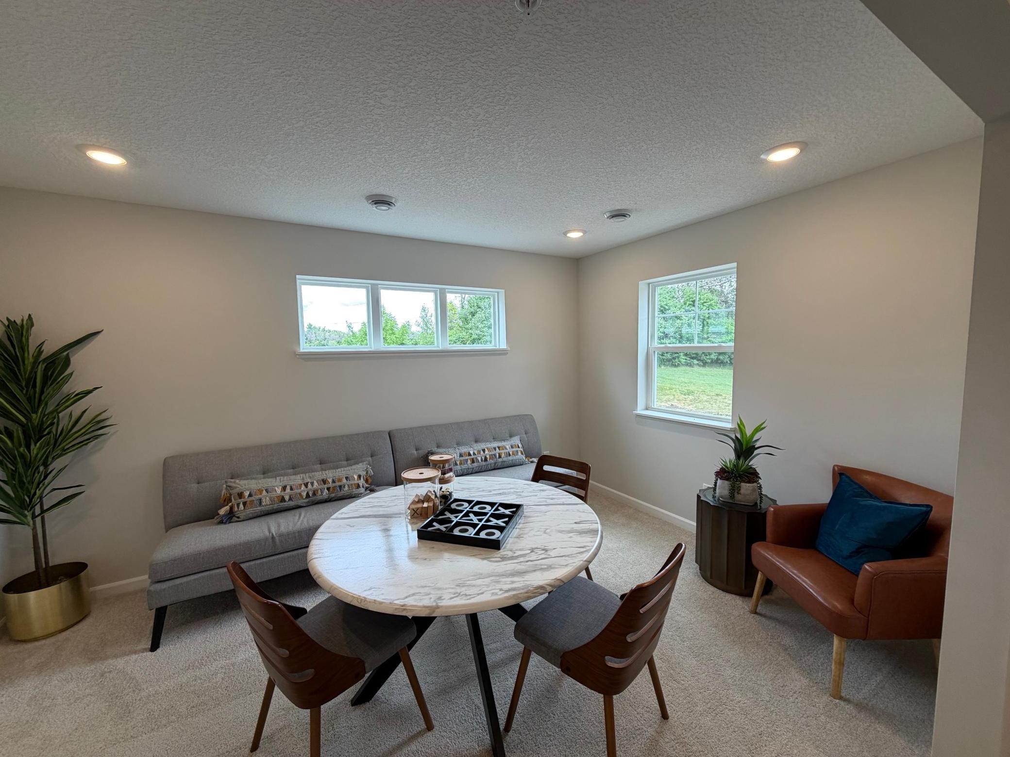 At the entry of the home, we have a spacious rec. space that is great, as a secondary living area, office, or even a makeshift 4th bedroom when you need added space!