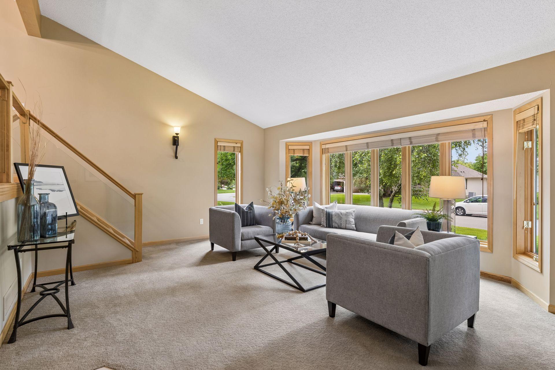Step in from the front door to a large front living room with freshly cleaned carpeting, fresh interior and exterior paint, high ceilings, and natural woodwork.