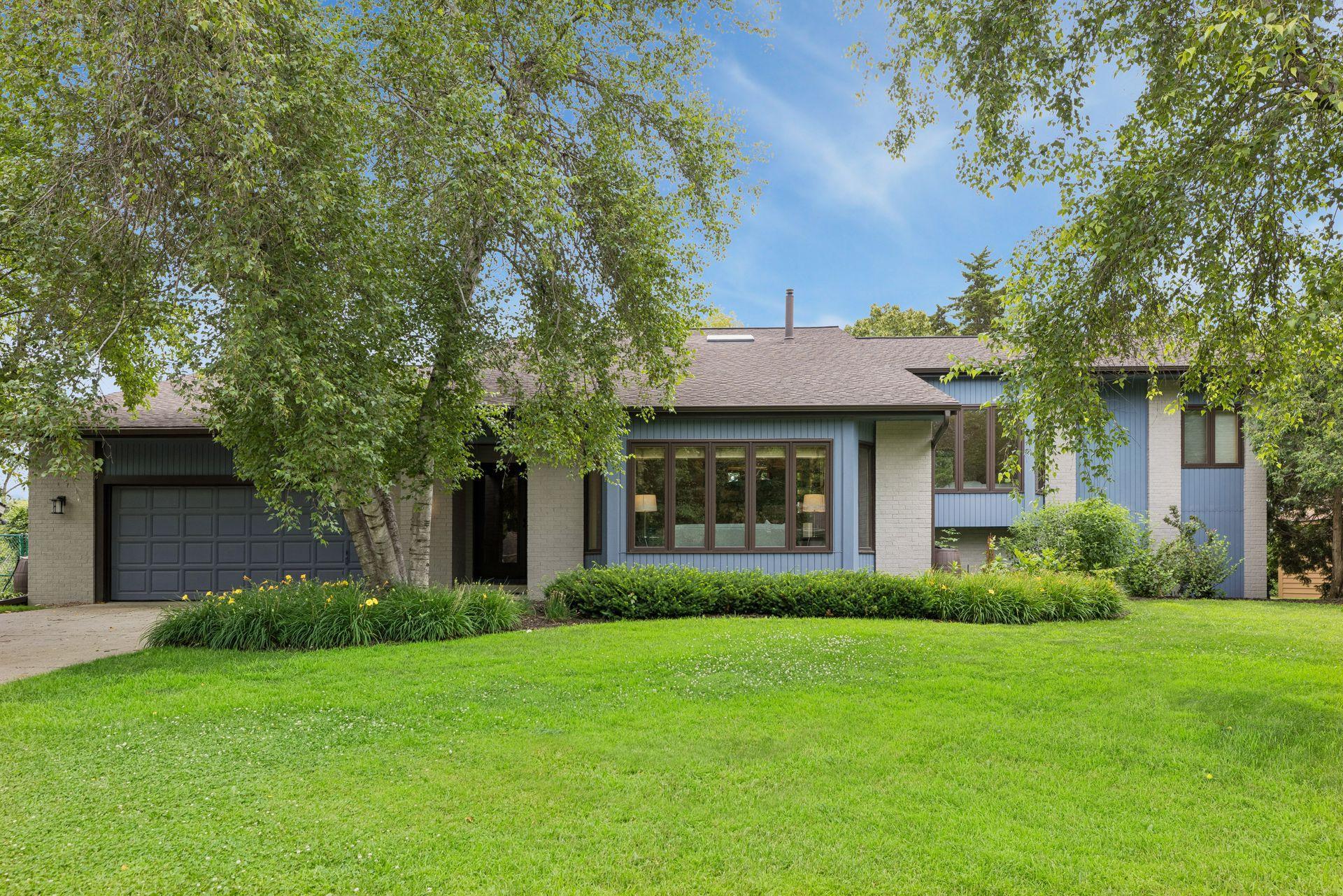 Spend summer at the lake! Modern walkout rambler on Mitchell Lake, a natural lake perfect for pontoons, paddleboards, kayaks, fishing. Oriented towards the lake to maximize panoramic views - beautiful in every season.