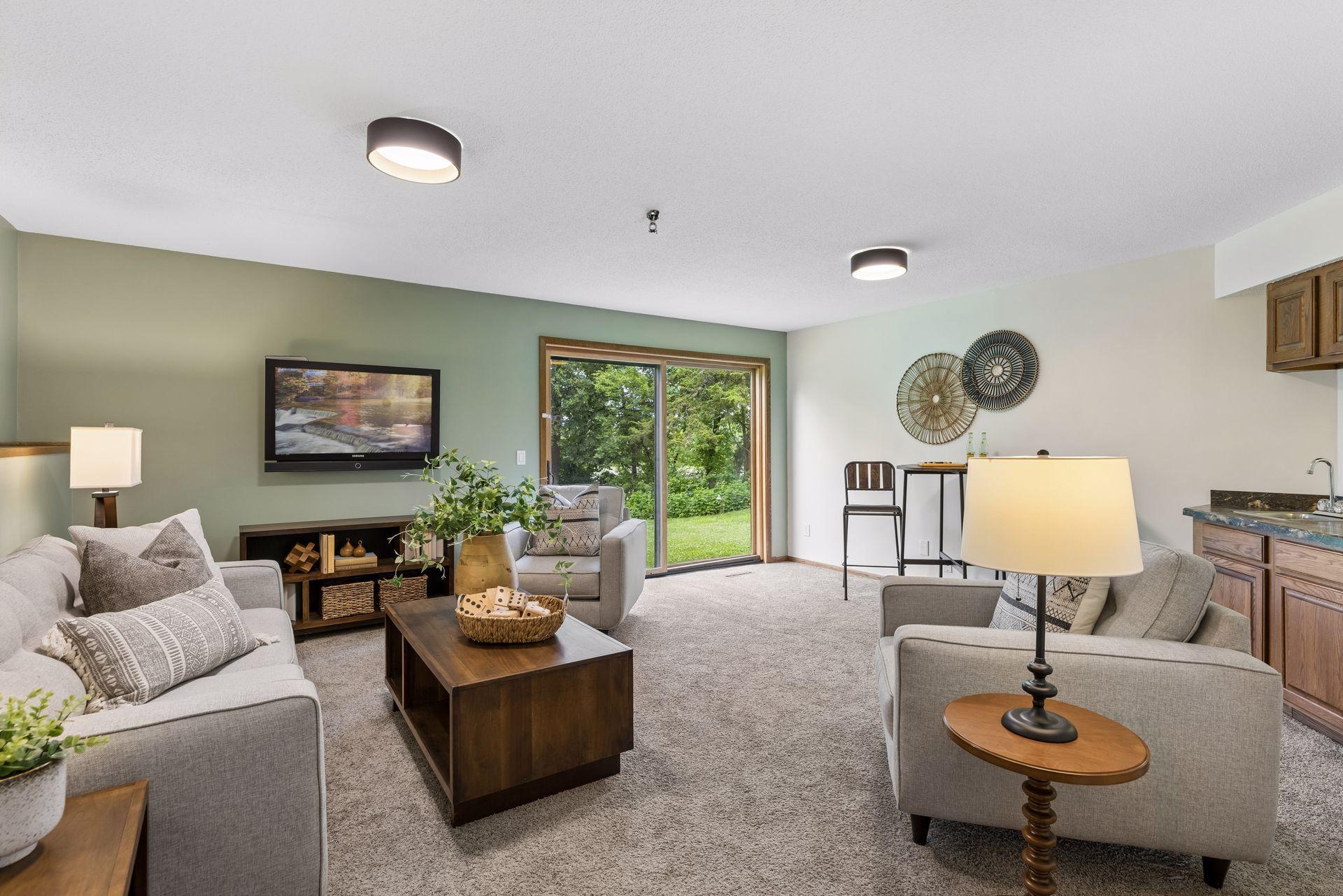 On the walkout garden level is a family room with wet bar, and sliding glass patio doors to backyard.