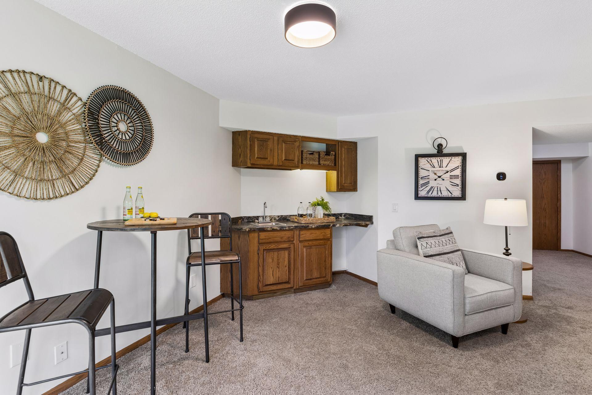 Wet bar area with sink and room for a beverage fridge.