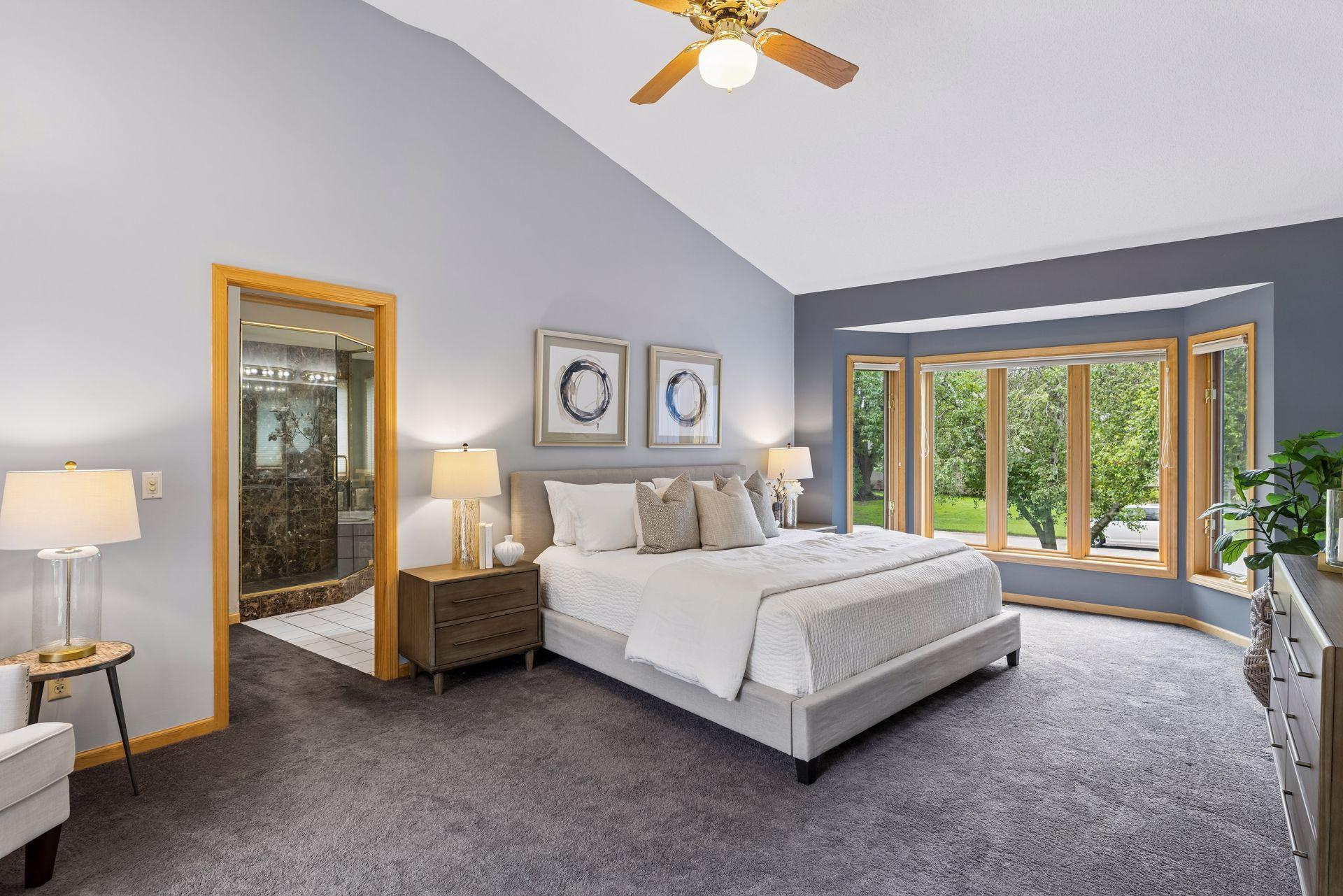 Primary bedroom suite is very spacious with bay window, private sliding patio doors to deck, walk-in closet and private bathroom.