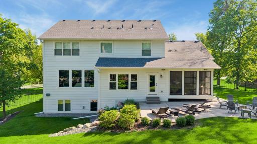 Enjoy a perfectly landscaped private backyard offering seasonal views of the lake