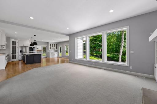 Enjoy a wall of windows overlooking private backyard