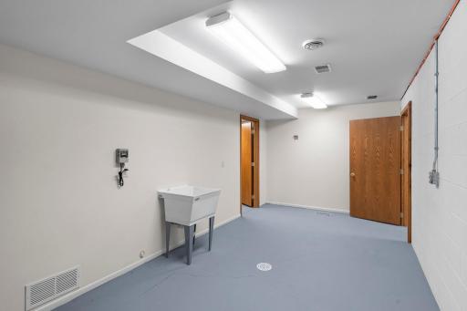 The second lower-level versatile flex room, complete with a utility sink.