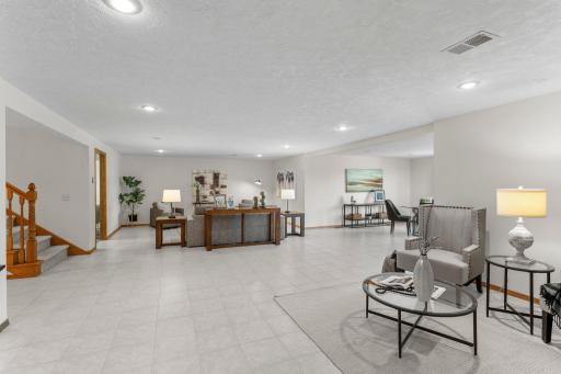 The expansive lower level is designed with entertaining in mind, offering a spacious open-concept layout.