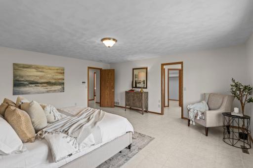 An alternate view of the main-level primary suite, highlighting the entrance to the ensuite bathroom.