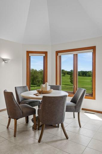 The informal dining area is highlighted by a vaulted ceiling and a large bay window that fills the space with natural light and offers stunning viewsâan ideal setting for enjoying everyday meals.