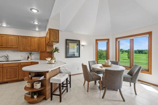 The space is finished with high-quality Italian tile flooring and equipped with brand-new stainless steel appliances. Adjacent to the kitchen is an inviting informal dining area.
