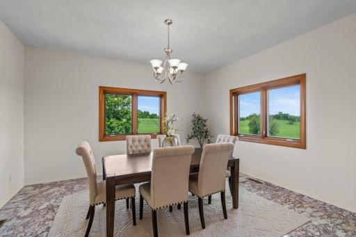 The elegant formal dining room is equally impressive, showcasing Italian marble flooring, a sophisticated chandelier, and two large windows that add brightness and charm to the spaceâperfect for hosting dinner parties or special gatherings.