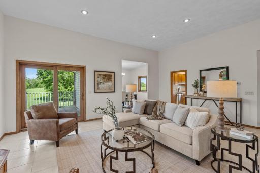 The main-level living room features high ceilings and high-quality Italian tile flooring that seamlessly extends throughout the main floor.
