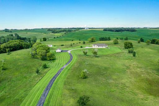 A long, private quarter-mile asphalted driveway leads you into the heart of the property, setting the tone for the privacy and seclusion that await.
