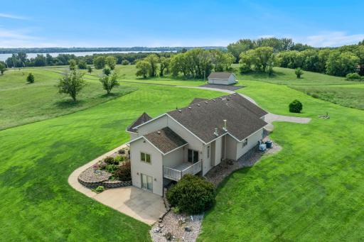 Breathtaking rear exterior view showcasing the home and expansive surrounding land.