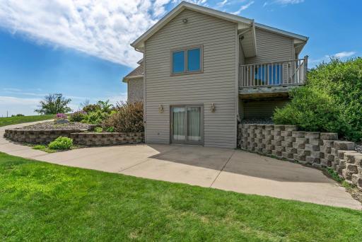 The large patio, accessible from the lower-level walkout, is perfect for entertaining or relaxing outdoors.