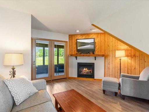 The living room space offers a pull out sleeper sofa if extra space is needed, nice LVP flooring, a gas fireplace for the cooler season and atrium door out to a screened in porch.