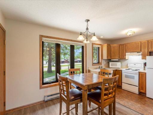 Nice informal dining area with easy care LVP flooring and big 3 wide casement window overlooking Bay Lake.
