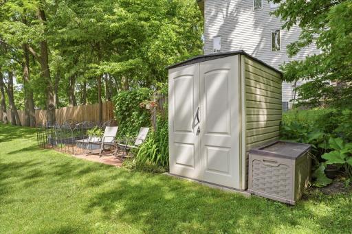 A convenient storage shed provides additional space for tools and seasonal equipment, while nearby garden and seating areas add charm and functionality to the outdoor living experience.