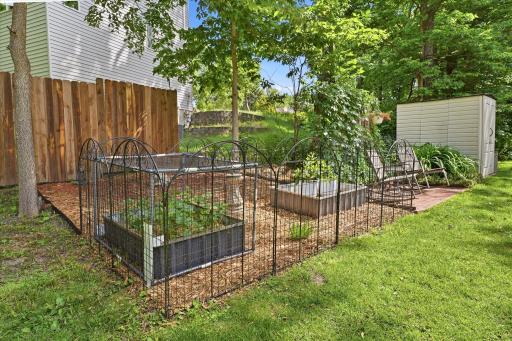 Garden enthusiasts will appreciate the thoughtfully designed raised garden beds, offering the perfect space to grow vegetables, herbs, or flowers in a private backyard setting.