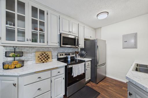 Newer stainless steel appliances, backsplash, and updated electrical box.